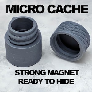 May include: Two gray, cylindrical micro caches with the text "MICRO CACHE", "STRONG MAGNET", and "READY TO HIDE". One cache has a threaded top, and the other has a textured, ridged design. The caches are designed to hide small items.