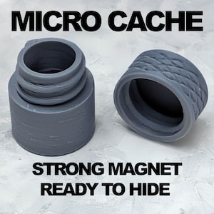 May include: Two-piece gray micro cache with the text "MICRO CACHE", "STRONG MAGNET", and "READY TO HIDE". The cache has a threaded design and a textured lid. The cache is designed to hide small items.