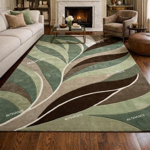May include: A rectangular area rug featuring a large-scale, abstract leaf pattern in shades of sage green, olive green, dark brown, and beige. The design consists of sweeping, curved shapes that create a flowing, organic composition across the surface.