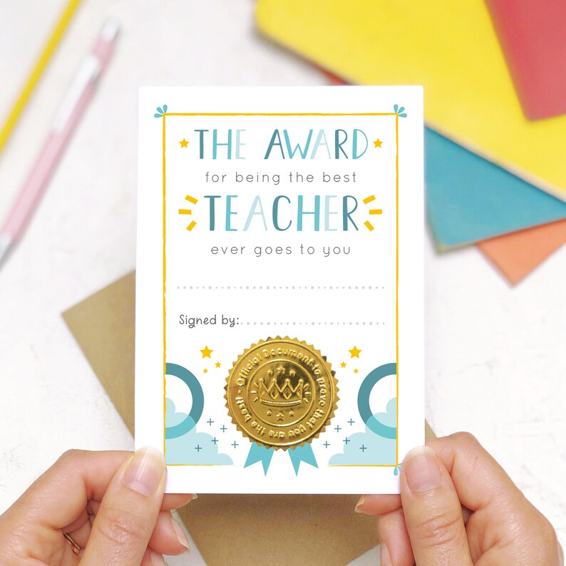 May include: A white card with a gold seal and the text "THE AWARD for being the best TEACHER ever goes to you" and "Signed by:"