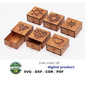 May include: A collection of small, wooden boxes with decorative cut-out designs on the lids. The boxes have pull-out drawers and are made of light-colored wood. The lids feature patterns like a rose, hearts, and a snowflake. The text "digital product" is visible.