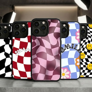 May include: A collection of phone cases with various checkerboard patterns in black and white, red and white, and pink. One case has the word "stara" in white script, and another has the word "smile" with a flower and smiley faces.