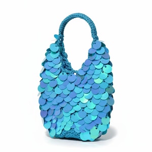 May include: A small, turquoise sequin handbag with a crocheted handle. The bag is covered in overlapping, iridescent sequins that create a shimmering effect. The handle is a matching turquoise colour, and the bag has a rounded shape.