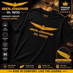 Pode incluir: Uma t-shirt preta de manga curta com um gráfico dourado de uma águia estilizada com as asas abertas sobre o texto GOLDWING GL 1800. O design está centrado no peito e a t-shirt é feita de 100% algodão com uma gola redonda.