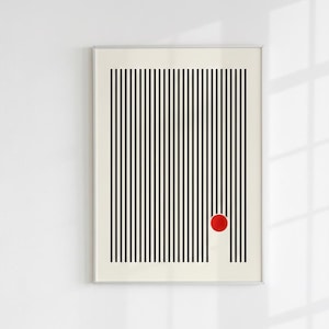 以下が含まれることがあります： クリーム色の背景に垂直な黒い線が描かれた、額装された抽象的なアートプリント。右下に赤い円が1つ配置されています。このアートワークは白い壁に展示されています。