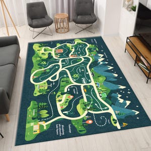 May include: A large rectangular play rug with a road map design. The rug features a green landscape with roads, buildings, and mountains. The roads are white, and the landscape is a mix of green and blue. The rug is designed for children's play.