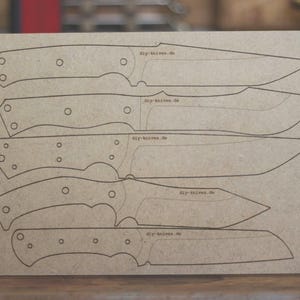 May include: A rectangular piece of tan cardstock features six knife templates in black outline. Each template has a different blade shape and handle design. The text "diy-knives.de" is printed on each template.