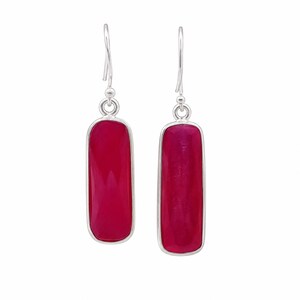 May include: A pair of drop earrings featuring elongated, rectangular, faceted deep pink stones set in polished silver frames. Each earring hangs from a simple silver hook, showcasing a smooth, reflective surface and a vibrant, saturated color.