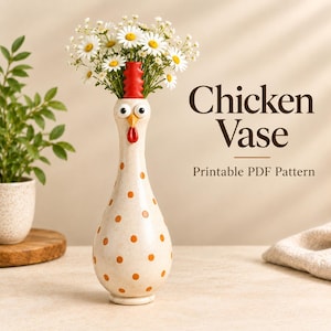 May include: A tall, cream-colored ceramic vase shaped like a chicken with orange polka dots, a red comb, and a red wattle. The vase features large white eyes with black pupils and is filled with a bouquet of white daisies. Text reads Chicken Vase.