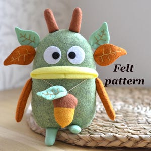 May include: A set of three ceramic mugs with a speckled, matte finish. The mugs are in shades of cream, light gray, and dark gray. Each mug has a simple, minimalist design and a rounded handle.