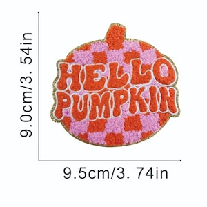May include: A pumpkin-shaped patch with the text "HELLO PUMPKIN". The patch is 3.54 inches wide and 3.74 inches tall. The design features a pink and orange checkered pattern with orange text and a gold glitter border.