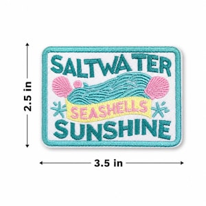May include: Rectangular patch with the words "SALTWATER SEASHELLS SUNSHINE" in white, teal, and yellow. The patch features a teal wave design, pink seashells, and starbursts. The patch measures 3.5 inches wide and 2.5 inches high.