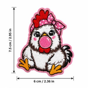 May include: Embroidered patch of a cartoon chicken with a pink bow, measuring 2.95 inches tall and 2.36 inches wide. The chicken has a red comb, a pink bubble, and is outlined in pink.