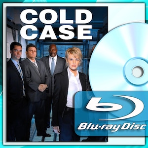 May include: A Blu-ray disc for the television show "Cold Case" featuring a group of people in suits. The title "Cold Case" is in large white letters at the top. The Blu-ray Disc logo is in the bottom right corner.