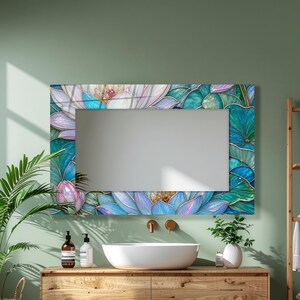 May include: A rectangular wall mirror featuring a decorative border with a stained glass-style print of blooming lotus flowers in shades of teal, blue, and soft purple, with thin gold-toned lines outlining each petal and leaf shape.