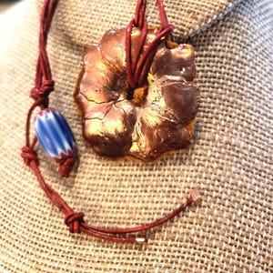 CoPPeR SmELt SpLaSh ArT FLoWeR TaLisMan NeCkLaCe  Healing, Safety, Love