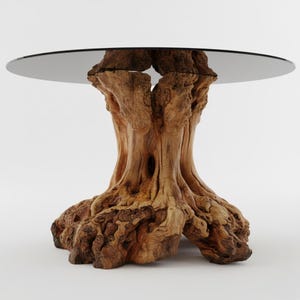 May include: A round table with a dark glass top supported by a natural wood base. The base is made from a tree trunk, showcasing the wood's texture and colour. The table's diameter is approximately 122 cm.