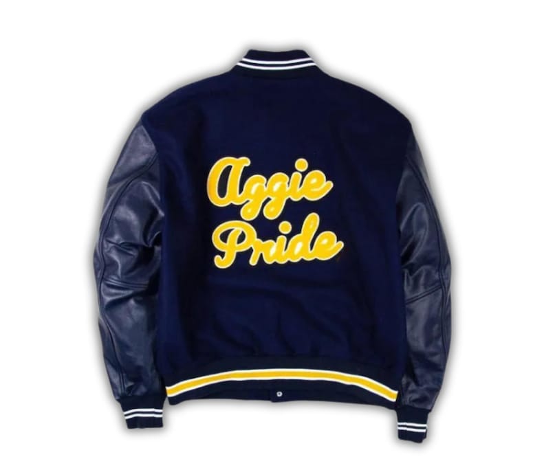 May include: Navy blue letterman jacket with leather sleeves. The back of the jacket features the words "Aggie Pride" in yellow script. The jacket has white and yellow striped trim on the collar, cuffs, and waist.