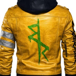 May include: Mustard yellow leather jacket with a black hood and a green graphic on the back. The jacket has silver accents on the sleeves and the word "CYBERPUNK" printed on the right sleeve.
