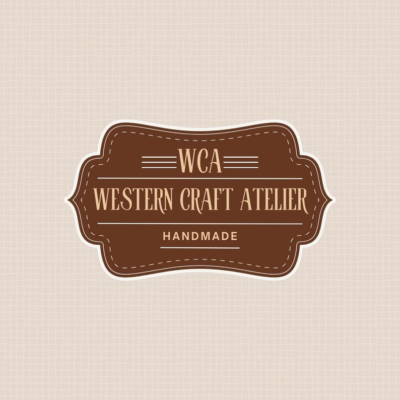 May include: A brown and white logo with the text "WCA" above "WESTERN CRAFT ATELIER" and "HANDMADE". The logo is in a decorative shape with a stitched border, set against a beige textured background.