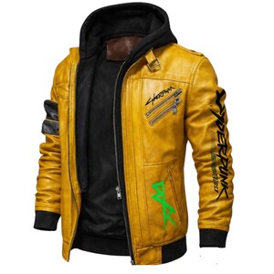 May include: Mustard yellow leather jacket with a black hooded insert. The jacket features black accents on the sleeves and the text "Cyberpunk" in black on the right sleeve and "Sherpunk" on the chest. Green text is also visible.