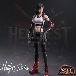May include: A detailed action figure of a female character from Final Fantasy. She wears a white and black top, black skirt, and red boots. The figure has black hair and is posed in a dynamic stance. The background features the text "Hellfest Studios" and "STL".