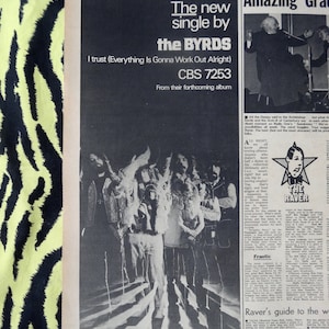 May include: A black and white photograph of a band, The Byrds, with the text "The new single by the BYRDS I trust (Everything Is Gonna Work Out Alright) CBS 7253 From their forthcoming album" printed above the band.