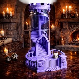 May include: A purple dice tower featuring a clear cylindrical center with an internal spiral staircase, a crenelated top, and a gated base with a balcony. A white six-sided die sits on the balcony, while two black dice rest nearby on the surface.