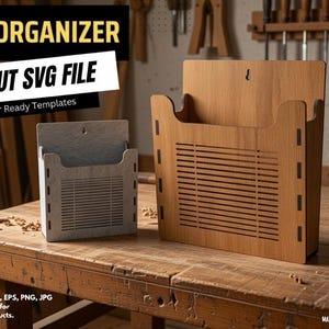 May include: Two wall organizers made of light-colored wood and grey material, featuring a slatted front design and a keyhole slot for mounting. The text reads WALL ORGANIZER LASER CUT SVG FILE, Design By Tofigh4lang, and MATERIAL THICKNESS: 3MM & 1/8INCH.
