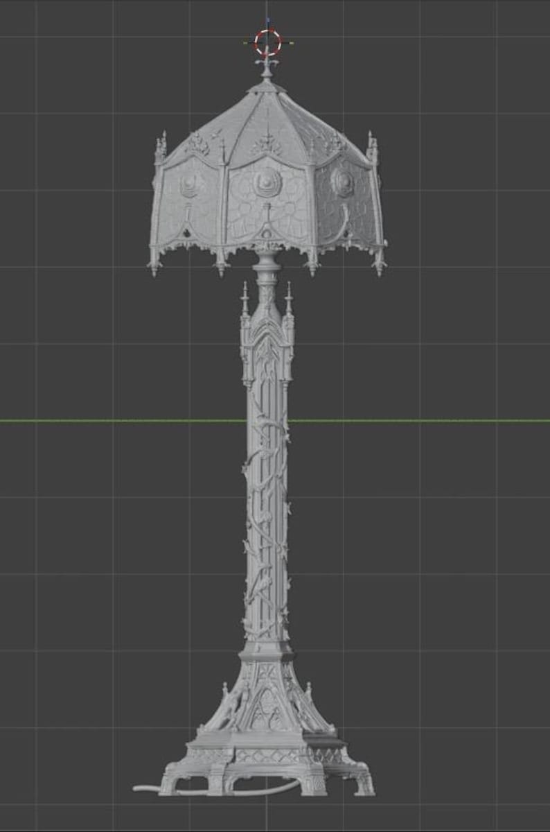 May include: A grey 3D digital model of a floor lamp featuring an ornate, multi-faceted shade with intricate relief patterns and a tall, slender central column decorated with climbing vine motifs, resting on a wide, detailed architectural base.