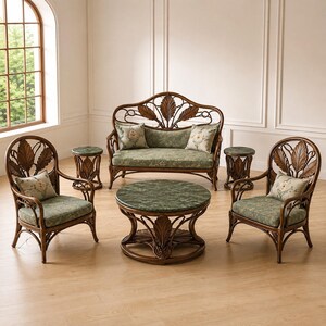 May include: A furniture set consisting of a two-seater sofa, two armchairs, a round coffee table, and two small round side tables. Each piece is crafted from dark brown wood with leaf-shaped backrests and green patterned fabric cushions.
