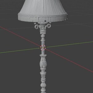 May include: A grey 3D digital model of a floor lamp featuring a pleated lampshade with a fringed bottom edge. The lamp stand is highly detailed with ornate carvings, a slender central column, and a wide, decorative circular base.