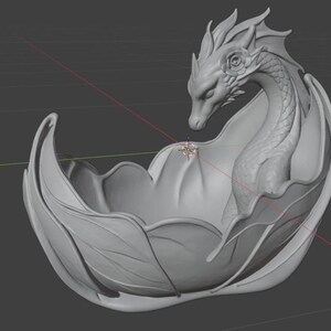 Pu&ograve; includere: Una scultura di drago grigio, renderizzata in 3D, all'interno di una ciotola a forma di foglia stilizzata. Il drago presenta squame dettagliate, ali e un ornamento a forma di rosa. I bordi della ciotola si incurvano con grazia.