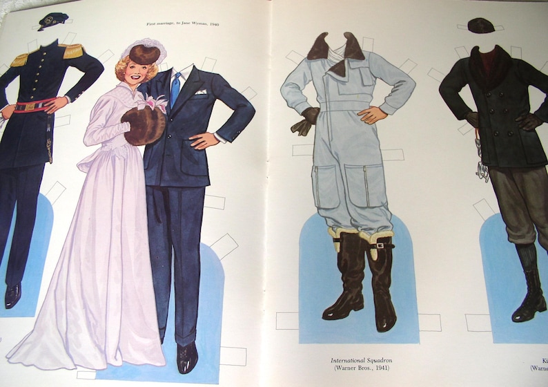 May include: A vintage paper doll set featuring illustrated figures and various outfits including a military uniform, a wedding gown, a dark suit, a light blue flight jumpsuit with a fur-lined collar, and a dark coat with brown trousers and boots.
