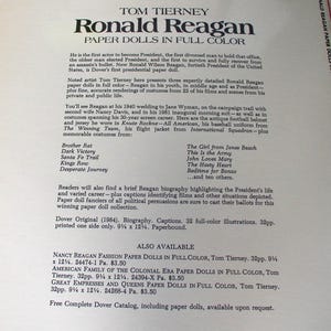 May include: A paperbound book titled Tom Tierney Ronald Reagan Paper Dolls in Full Color. The cover features black text on a cream background, detailing a 1984 Dover publication with 32 pages of illustrations measuring 9.25 inches by 12.25 inches.