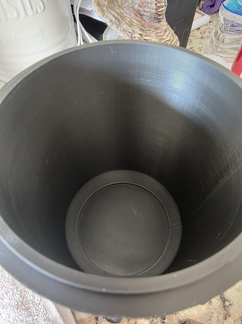 Top-down view inside gothic storage canister showing smooth cylindrical interior, flat reinforced base, and deep capacity for organizing bathroom, kitchen, office, or gothic decor items.