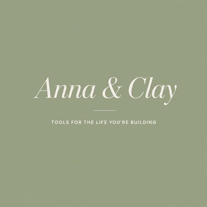 May include: A sage green background with the words "Anna & Clay" in a delicate, off-white script font. Below, the text reads "TOOLS FOR THE LIFE YOU'RE BUILDING" in a smaller, sans-serif font.