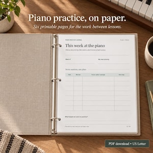 May include: A beige fabric-covered three-ring binder containing a white piano practice journal page. The page features the text Piano practice journal, This week at the piano, and a table for tracking practice sessions, dates, and notes.
