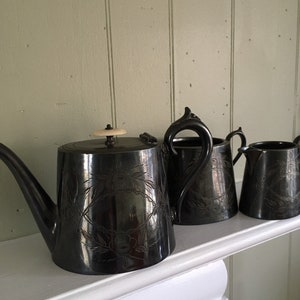 Antique teapot, creamer and sugar