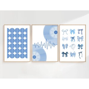 May include: Three framed art prints with a light blue color scheme. The left print features a pattern of blue circles. The center print shows two blue vinyl records with a sound wave. The right print displays various blue bows.