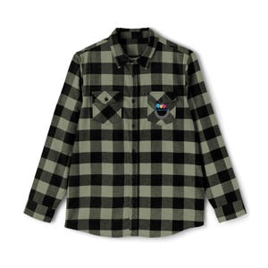 May include: A long-sleeved, button-down flannel shirt in a black and olive green plaid pattern. The shirt has two chest pockets and a small embroidered logo on the left pocket. The shirt is made of a soft, woven fabric.