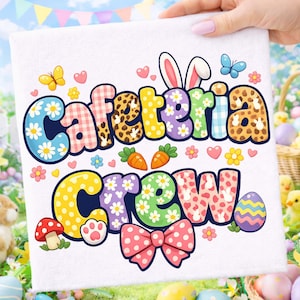 May include: White square towel with the words "Cafeteria Crew" in colorful, patterned letters. The design includes Easter-themed graphics like butterflies, carrots, flowers, and an Easter egg. A pink bow and bunny ears are also featured.