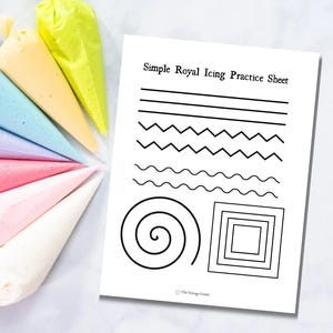May include: A white sheet with black line patterns for practicing royal icing techniques. The sheet is titled "Simple Royal Icing Practice Sheet." Colorful piping bags filled with icing in various pastel shades are arranged nearby.