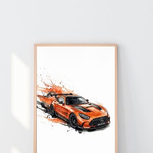 May include: Watercolor painting of an orange sports car with black accents and wheels. The car is depicted in motion with orange and black paint splatters. The artwork is framed in a light wood frame.
