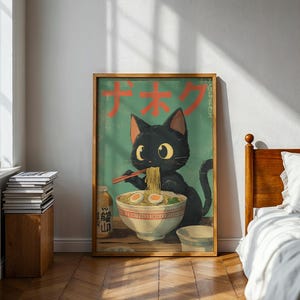 May include: A framed poster featuring a black cat enjoying ramen. The cat, with large yellow eyes, holds chopsticks and eats noodles from a bowl. The poster has Japanese text and a teal background. A bottle of sauce and a small bowl are also visible.
