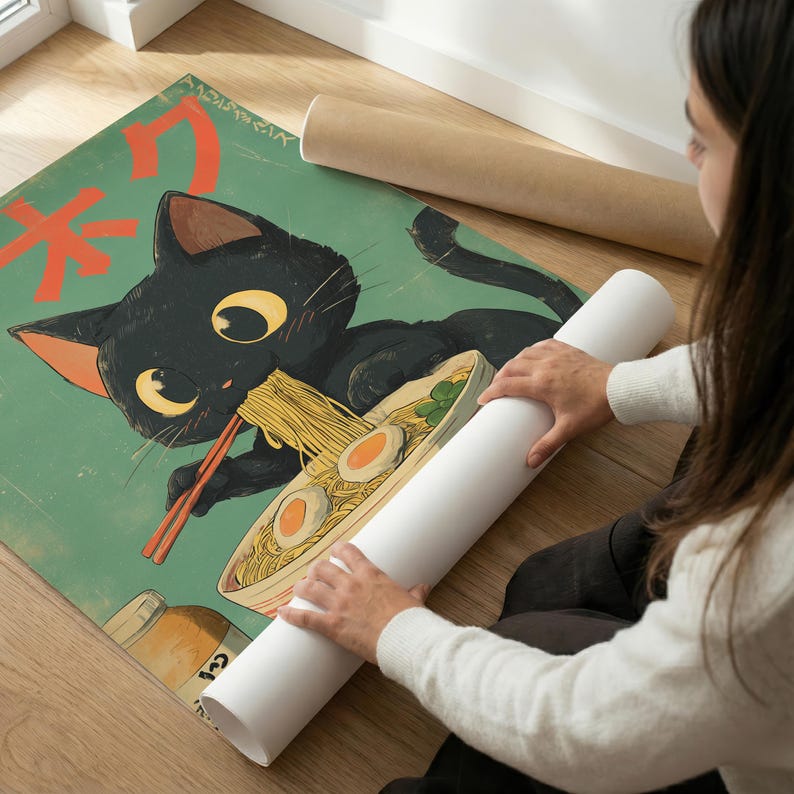 May include: A poster featuring a black cat eating ramen noodles with chopsticks. The cat has large yellow eyes and orange accents. The poster has Japanese text and is on a green background.