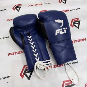 May include: Two navy blue boxing gloves with white laces. The gloves have black detailing and the word "FLY" is printed in white, along with a bird graphic. The brand name "FAYDON FIGHT GEAR" is visible in the background.