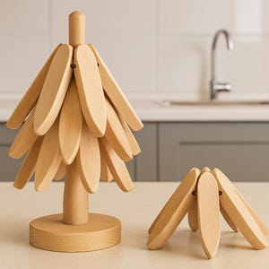 May include: Two wooden decorative items. One is a tree-shaped object with multiple wooden leaf-like pieces attached to a central stem and base. The other is a smaller, similar item, partially collapsed. Both are light brown.