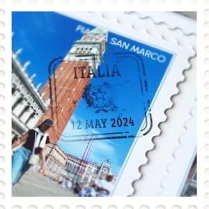 May include: A postage stamp featuring the San Marco bell tower in Venice, Italy, against a blue sky. The stamp reads "ITALIA" and "12 MAY 2024". The stamp has a white, scalloped border.