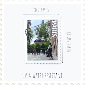 May include: A rectangular stamp featuring a photograph of the Eiffel Tower in Paris, France. The stamp is 2.75 inches by 3.46 inches and has the text "PARIS", "FRANCE", and "LA TOUR EIFFEL". The stamp is UV and water resistant.